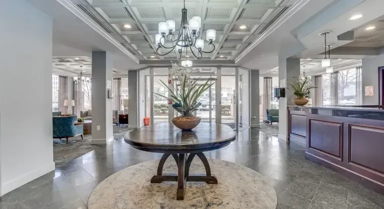 Seminary Towers grand lobby with chandelier and round table