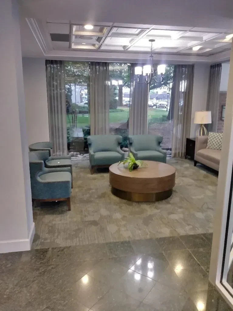 Seminary Towers lobby seating area with teal chairs